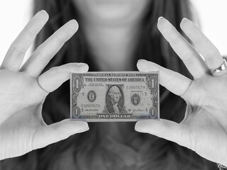 Wall Mural - Woman showing a tiny one dollar bill