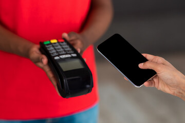 Wall Mural - Black man in red uniform holding POS machine for payment