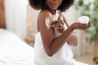 © Prostock-studio - Unrecognizable black lady applying body cream on shoulder after shower in morning at home