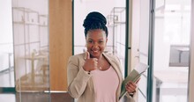 Happy And Smiling African Young Businesswoman Walking Through Modern Office And Giving A Thumbs Up. Confident Woman  Looking At Camera, Showing A Hand Sign With A Like Or Recommend Business Concept