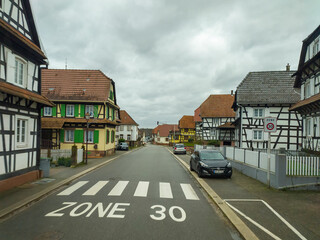 Wall Mural - view from the car window on the street with houses in France in the city of Betschdorf