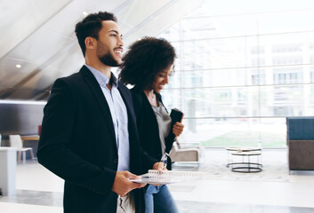 Let your drive keep moving you forward. Shot of a young businessman and businesswoman having a conversation while walking through a modern office.