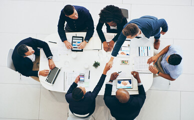 Poster - Opening more doors with successful business deals. High angle shot of a businessman and businesswoman shaking hands during a meeting in a modern office.