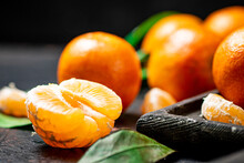 Peeled Fresh Tangerines. On A Black Background. High Quality Photo