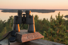 Binoculars On The Background Of Dawn. Nature In Summer. Islands In The Sea. Finland.