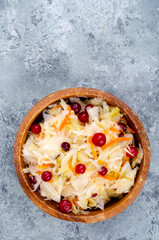 Wall Mural - Sauerkraut with red cranberries in wooden bowl. Studio Photo