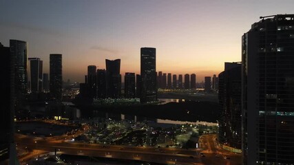 Wall Mural - Sunset in Abu Dhabi, aerial view on Al Reem island surrounded by modern skyscrapers