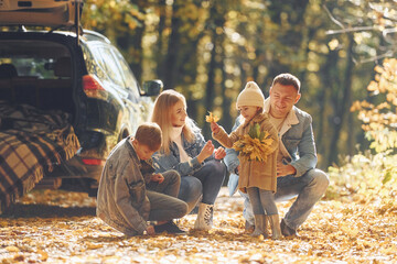 Wall Mural - Beautiful leaves. Happy family is in the park at autumn time together