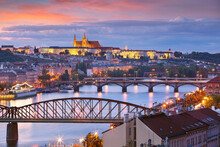 Prague At Sunset. Cityscape Image Of Prague, Capital City Of Czech Republic With St. Vitus Cathedral And Five Bridges Over Vltava River At Autumn Sunset.