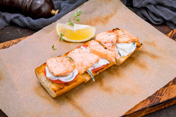 Canvas Print - Bruschetta with fried salmon and cheese and tomatoes on the board