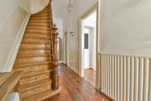 Hallway With Wooden Staircase With Decorative Elements On Banister