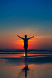 Happy women raise their hands
Concept of worshiping god On a blurred ocean and sky background silhouette style vertical