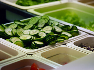 sliced ​​vegetables lie in containers on the showcase of the restaurant