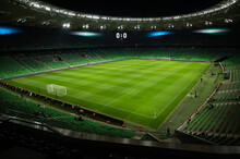 An Open Football Stadium With Empty Stands With Green Seats.