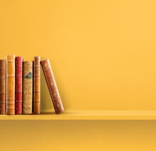 Row Of Old Books On Yellow Shelf. Square Background
