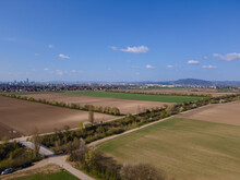 An Aerial Photograph Of An Irrigation Canal In Lower Austria With Fields And Paths On Either Side And A Dam. District 22, Donaustadt, Is In The Distance With UNO City Towers.