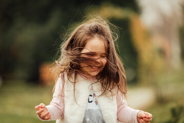 Wall Mural - Little girl having fun outside in the park