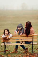 Wall Mural - Mother with two girls outdoors in the park