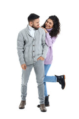 Sticker - Happy young couple in warm sweaters on white background