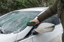 Manual Car Wash With Water And Soapy Sponge, Man Cleaning Dirt Automobile With Rag At Home Backyard Outdoor Winter Snowy Day. Vehicle Covered By Shampoo Chemical Detergents Car Wash Self Service