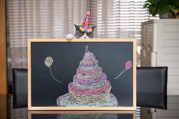 Canvas Print - cute british shorthair cat behind a blackboard with birthday cake celebrating her 1-year-old birthday