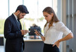 © Bangkok Click Studio - Caucasian male businessman employee typing keyboard looking at computer monitor when happy cheerful successful long curly blonde hair female businesswoman assistant open notebook discussing together