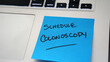 Sticky note reminder to schedule colonoscopy, an important screening for colorectal cancer.