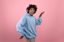 Silly Black Teenager In Headphones Listening To Music, Dancing Funny Egyptian Dance, Fooling Around On Pink Background