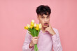 © Tatiana - portrait of a young man bouquet of flowers date romance posing pink background unaltered
