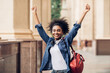 © Prostock-studio - Happy African American Student Girl Shaking Fists Celebrating Success Outside