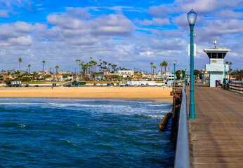 Wall Mural - Pacific ocean waves at the beach in a famous tourist destination viewed from Seal Beach pier in California, USA