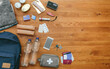 © David Pereiras - Top view of emergency backpack preparations with necessities
