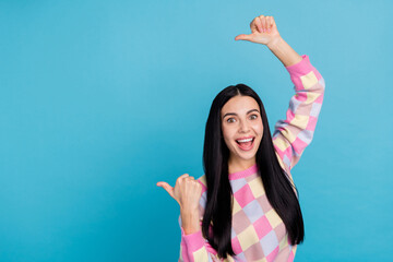 Wall Mural - Photo of funny excited lady dressed print pullover pointing thumbs back empty space isolated blue color background