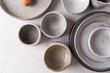 Handmade ceramic tableware, empty craft ceramic on a light background. Clay plates and cups