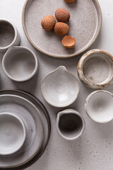 Wall Mural - Handmade ceramic tableware, empty craft ceramic on a light background. Clay plates and cups