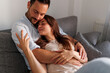 © Impact Photography - Couple relaxing and hugging at home