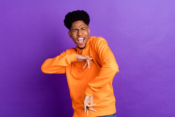 Wall Mural - Photo of funky happy young afro american man dance good mood funny isolated on purple color background