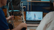 © DC Studio - Retired patients attending consultation on videoconference with doctor, talking about health care. Couple using online video call for telemedicine and telehealth with specialist on laptop.