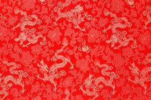 Red Fabric With A Dragon Pattern. The Concept Of The Chinese New Year. Copy Space. Red Background