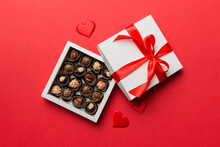 Delicious Chocolate Pralines In Red Box For Valentine's Day. Heart Shaped Box Of Chocolates Top View With Copy Space