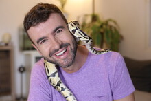 Cute Man Holding Exotic Ball Python