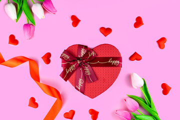 Red gift box in the form of a heart on a pink background. Valentine's Day.