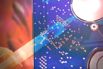 Vaccine syringe with a background of a computer chip.