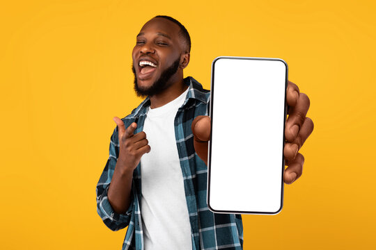 Wall Mural - Black guy showing white empty smartphone screen, closeup
