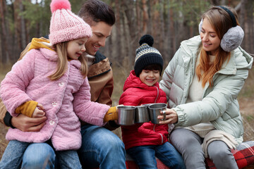 Canvas Print - Happy family with cups of hot tea spending time together in forest