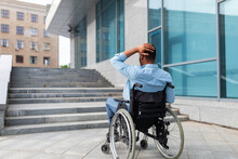 Irritated Impaired Black Man In Wheelchair Having No Possibility To Enter Building Without Ramp, Outdoors