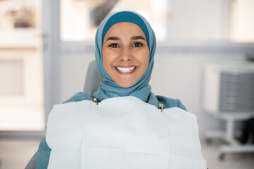 Wall Mural - Portrait Of Happy Muslim Woman Sitting In Dental Chair After Treatment