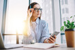 © BullRun - Pensive female blogger in optical eyewear for vision protection sitting at coworking desktop and thoughtful looking away while creating publication ideas and content plan,pondering woman with cellular