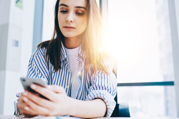 Wall Mural - youthful caucasian blogger checking smartphone notification for installing application, millennial g