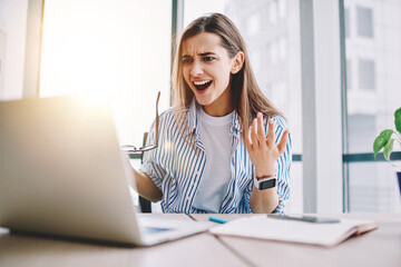 Wall Mural - angry stressed female freelancer irritated with bad internet connection sitting at desktop with netb